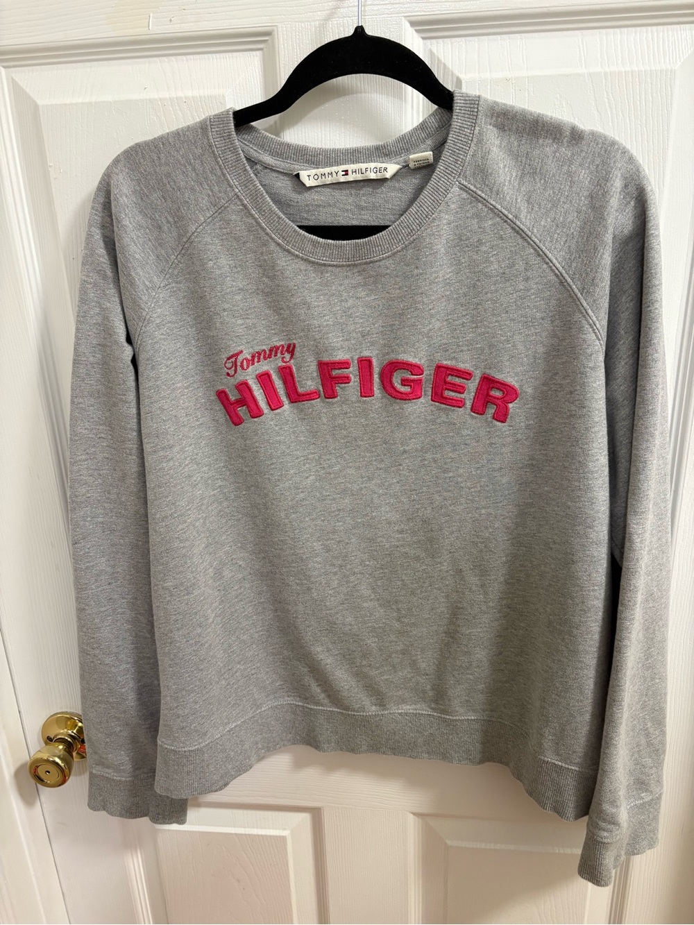grey Tommy Hilfiger crewneck sweatshirt featuring a red  embroidered logo,